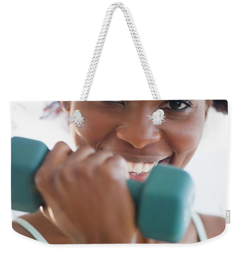 People Weekender Tote Bag featuring the photograph Black Woman Exercising With Hand Weights by Jgi/jamie Grill