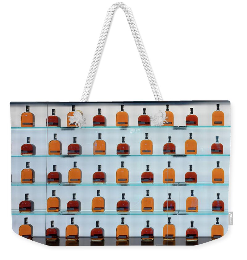 Woodford Reserve Weekender Tote Bag featuring the photograph Bourbon Bottles by Susan Rissi Tregoning