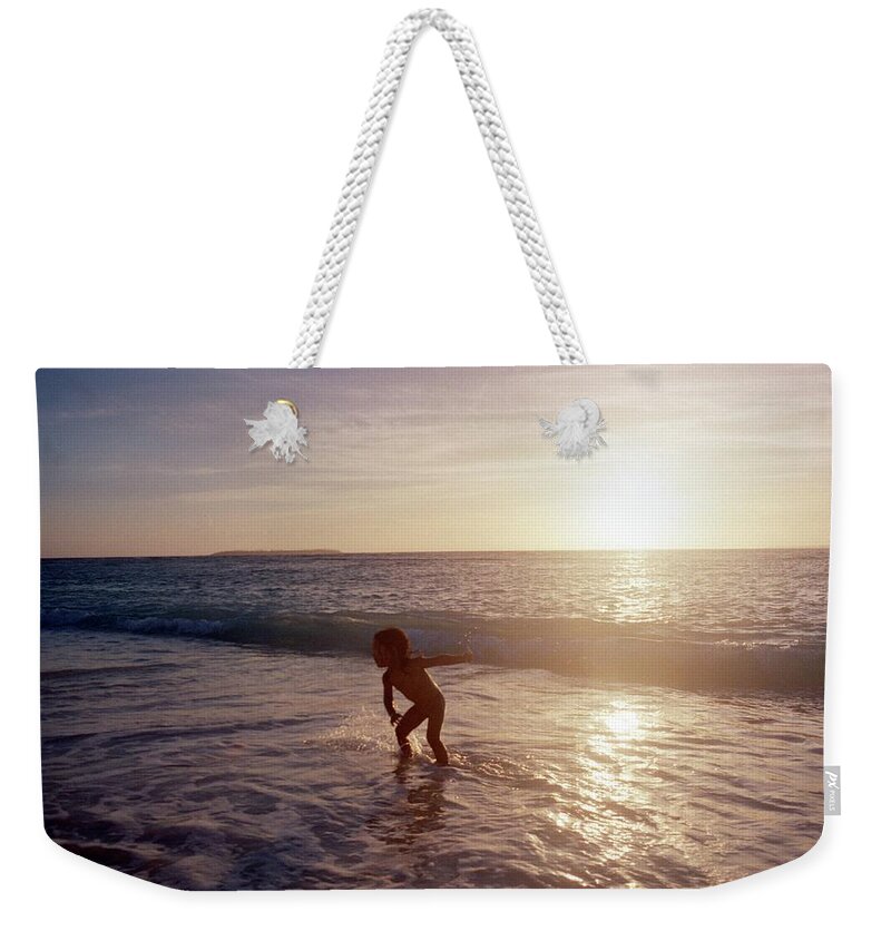 Three Quarter Length Weekender Tote Bag featuring the photograph Boy Who Play On The Beach by Gen Umekita