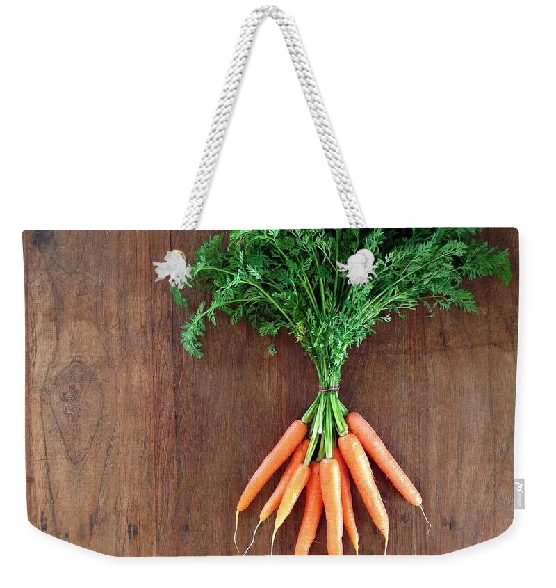Bunch Weekender Tote Bag featuring the photograph Bunch Of Baby Carrots Laying On Wooden by Jodie Griggs