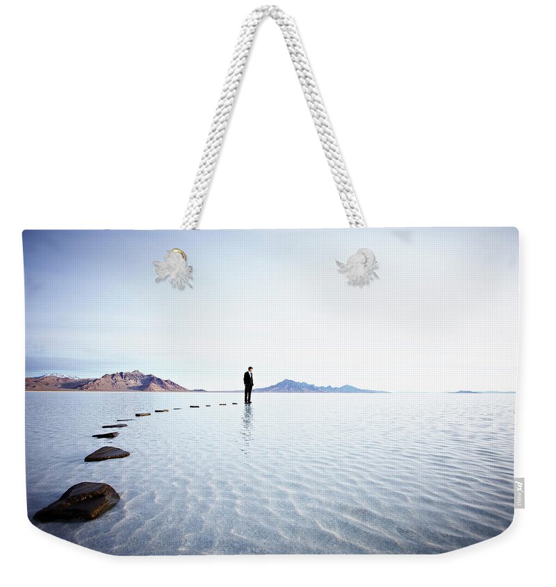 Problems Weekender Tote Bag featuring the photograph Businessman Standing At The End Of by Thomas Barwick