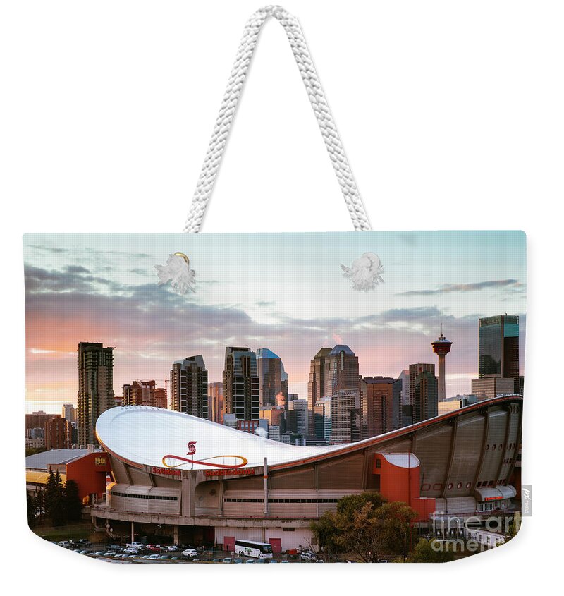 Calgary Weekender Tote Bag featuring the photograph Calgary Saddledome at sunset, Canada by Matteo Colombo