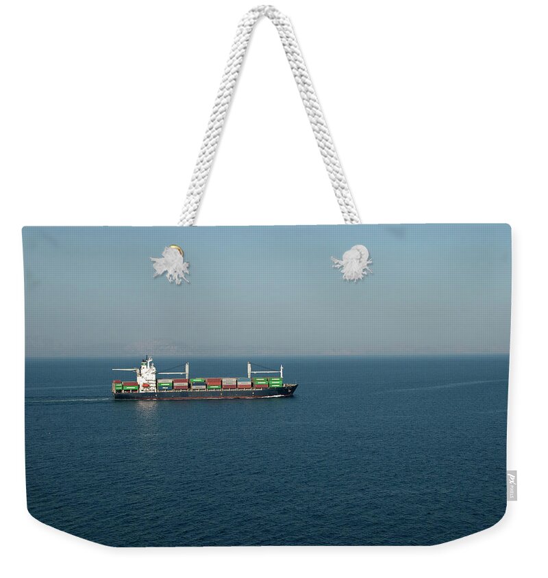 Freight Transportation Weekender Tote Bag featuring the photograph Cargo Ship At Sea by Mitch Diamond