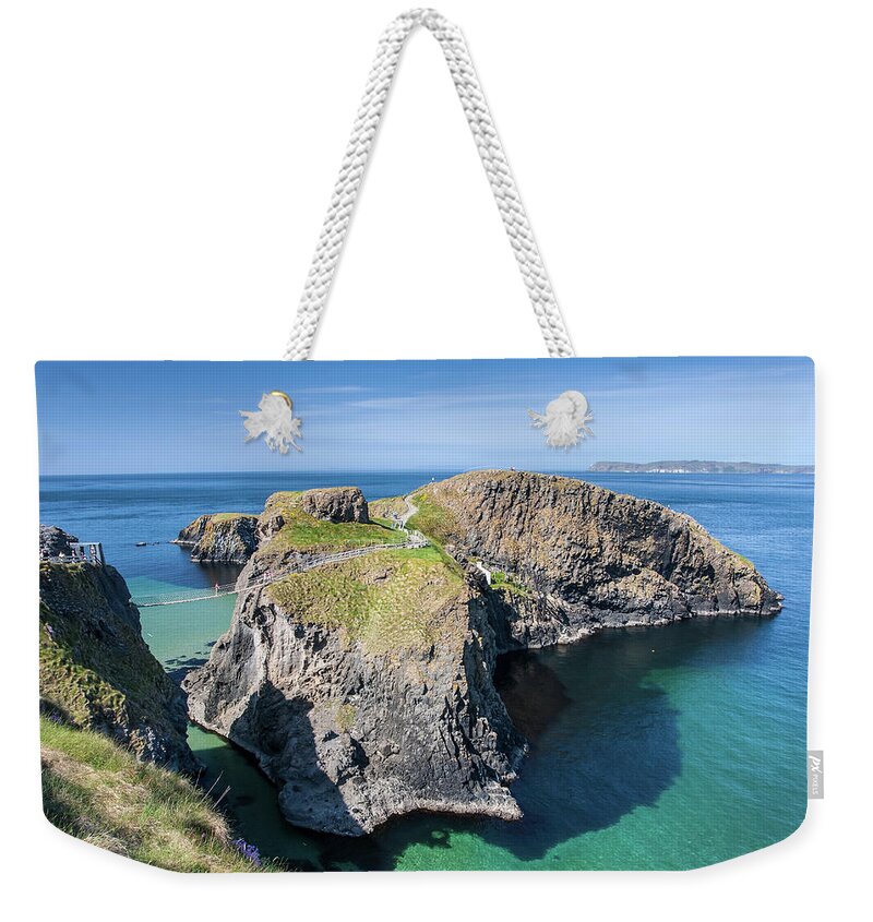 Tranquility Weekender Tote Bag featuring the photograph Carrick-a-rede Rope Bridge In Northern by Pierre Leclerc Photography