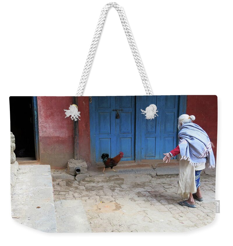 Woman Running After Chicken Weekender Tote Bag featuring the photograph Catch A Chicken by Inge Elewaut