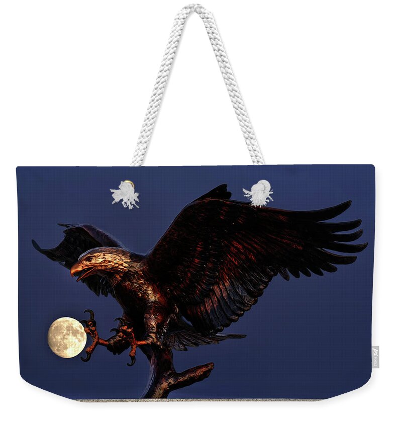 Eagle Moon Bronze Sculpture Bald Eagle Veteran Military Service Memorial Casting Night Scenic Astrophotography Weekender Tote Bag featuring the photograph Catching the Moon - cast bronze eagle at Stoughton Veterans Memorial site aligned with full moon by Peter Herman