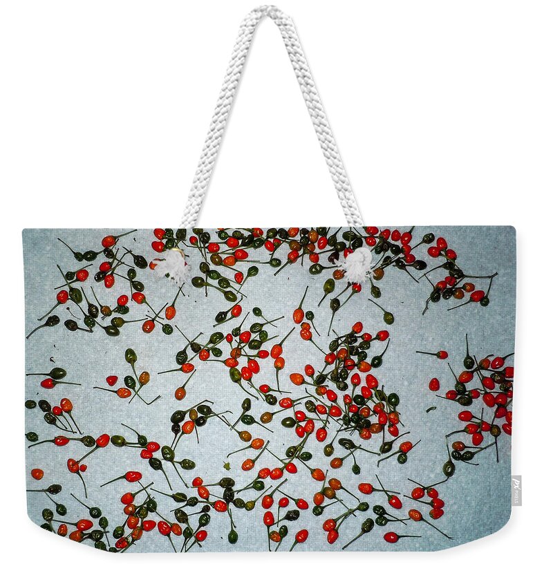 Peppers Weekender Tote Bag featuring the photograph Chili Pequins by Ivars Vilums