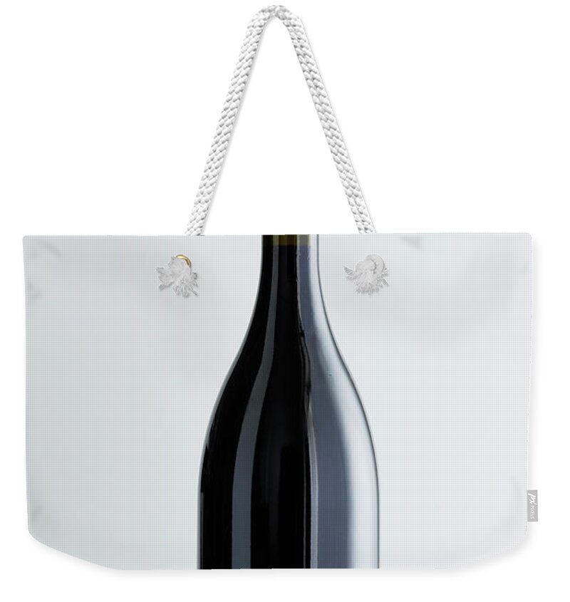 White Background Weekender Tote Bag featuring the photograph Close Up Of Bottle Of Bordeaux Wine by Brett Stevens