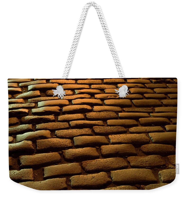 Outdoors Weekender Tote Bag featuring the photograph Close-up Of Cobblestone Street At Night by Jeff Spielman