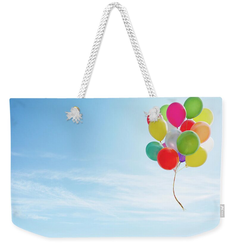 Bunch Weekender Tote Bag featuring the photograph Colorful Bunch Of Balloons Floating In by Luxx Images