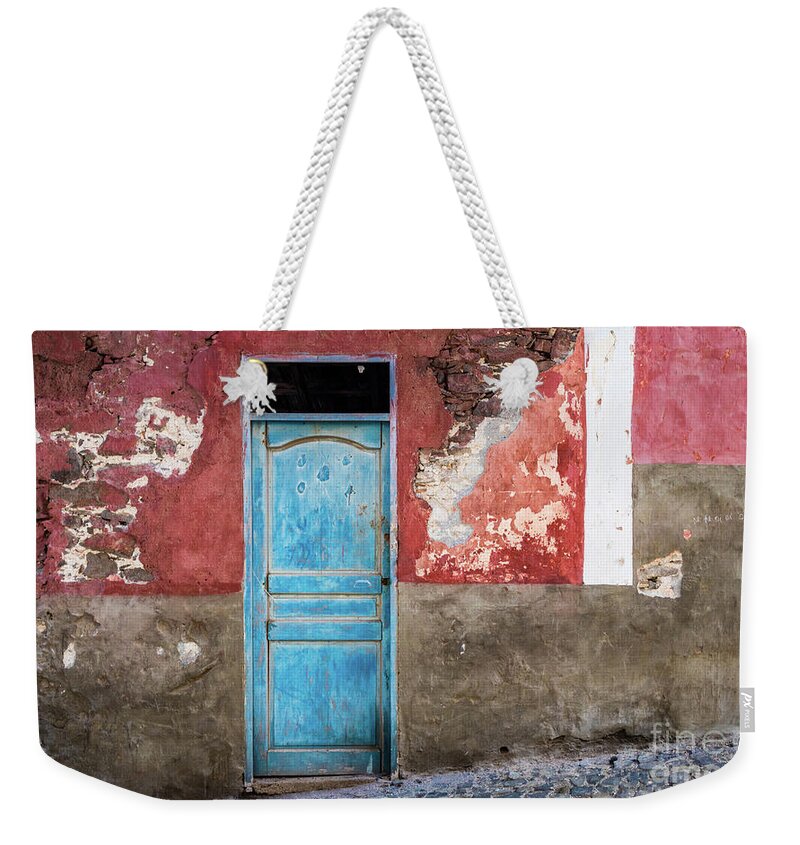 Wall Weekender Tote Bag featuring the photograph Colorful wall with blue door by Lyl Dil Creations