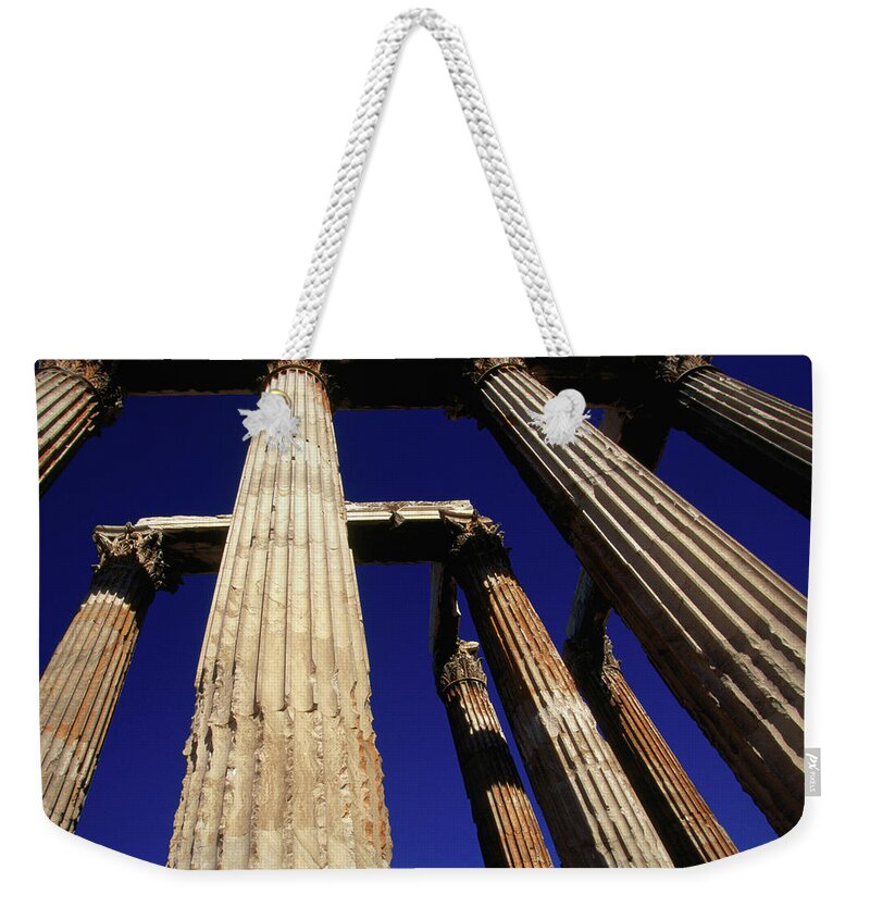 Greek Culture Weekender Tote Bag featuring the photograph Corinthian Columns Of The Temple Of by Lonely Planet