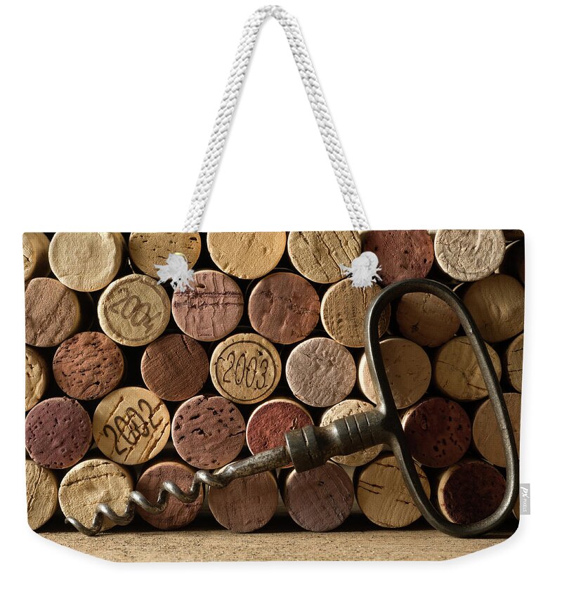 Corkscrew Weekender Tote Bag featuring the photograph Corks And Corkscrew by Markswallow