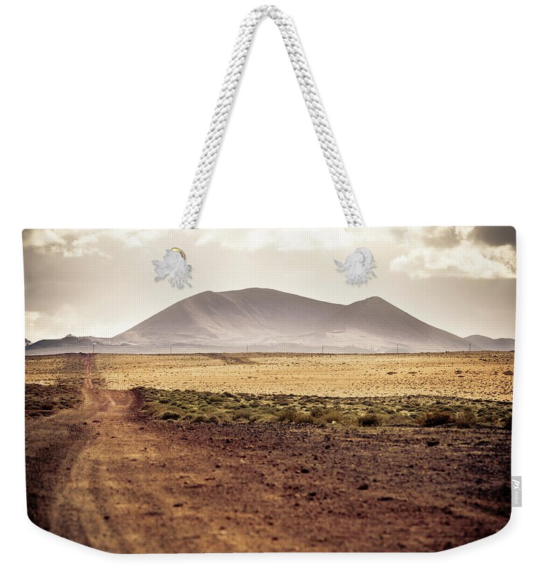 Scenics Weekender Tote Bag featuring the photograph Country Road In Volcanic Landscape by Zodebala