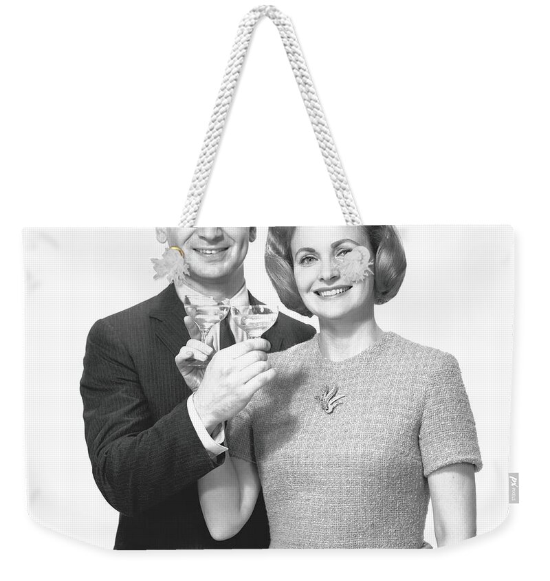 Heterosexual Couple Weekender Tote Bag featuring the photograph Couple Toasting Champagne In Studio by George Marks