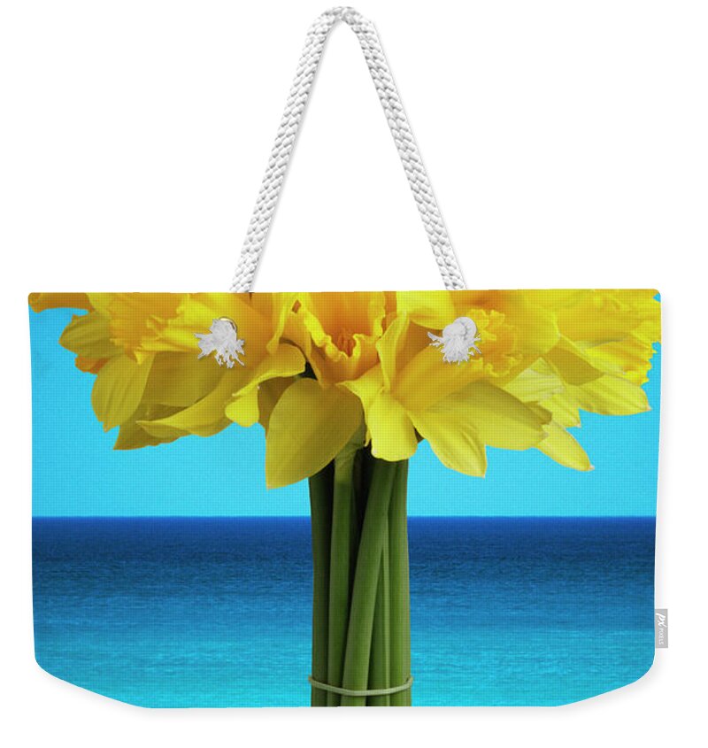 Bouquet Weekender Tote Bag featuring the photograph Daffodils Against Blue Sky by Terry Mccormick