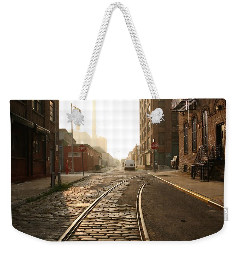 Dawn Weekender Tote Bag featuring the photograph Deserted Brooklyn Dumbo Cobblestone by Cribbvisuals