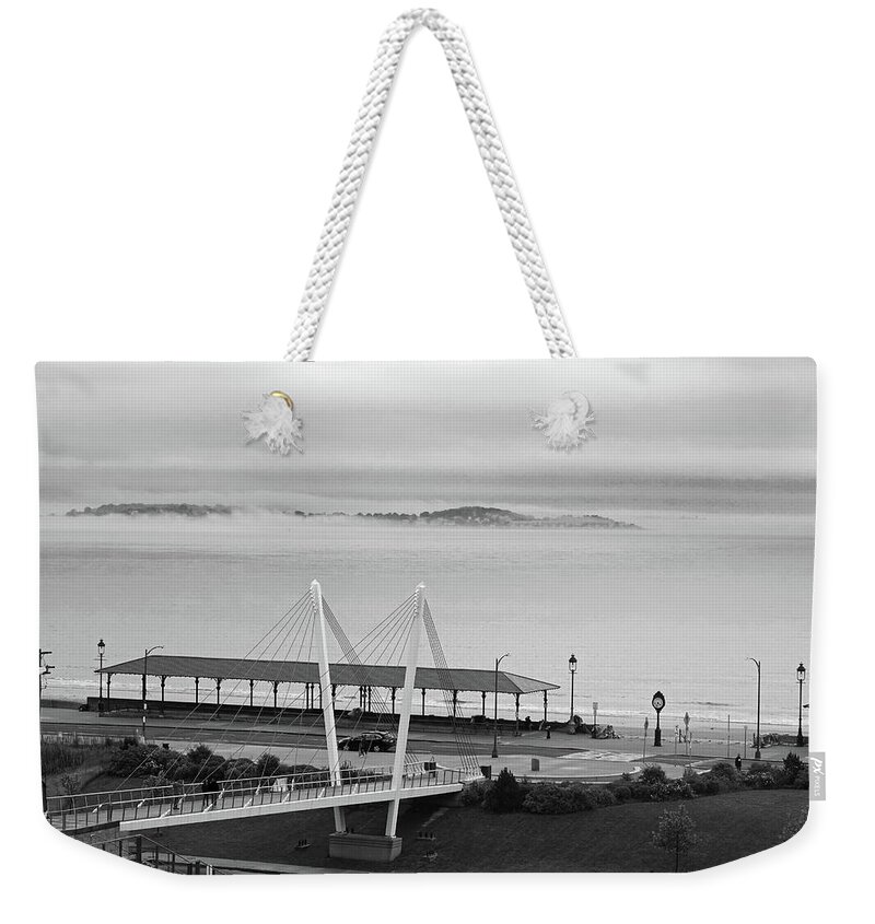 Revere Weekender Tote Bag featuring the photograph Dramatic Fog Over Nahant From Revere Beach Revere MA by Toby McGuire