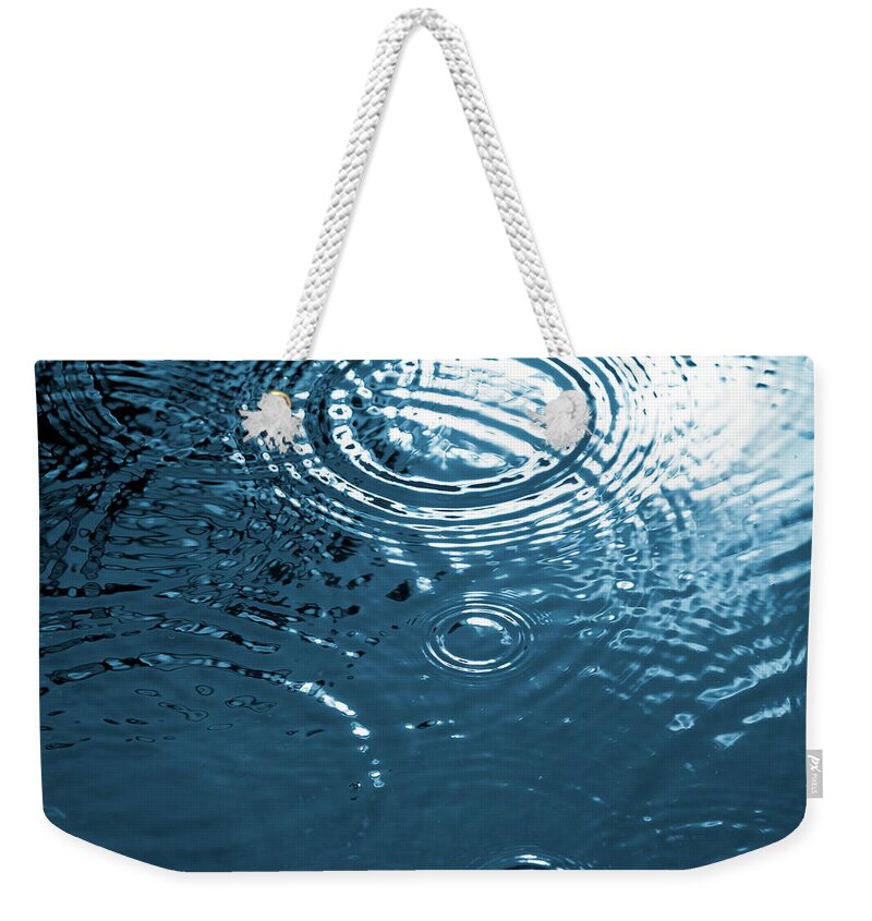 Blurred Motion Weekender Tote Bag featuring the photograph Drops Falling On Water Surface by Ldf