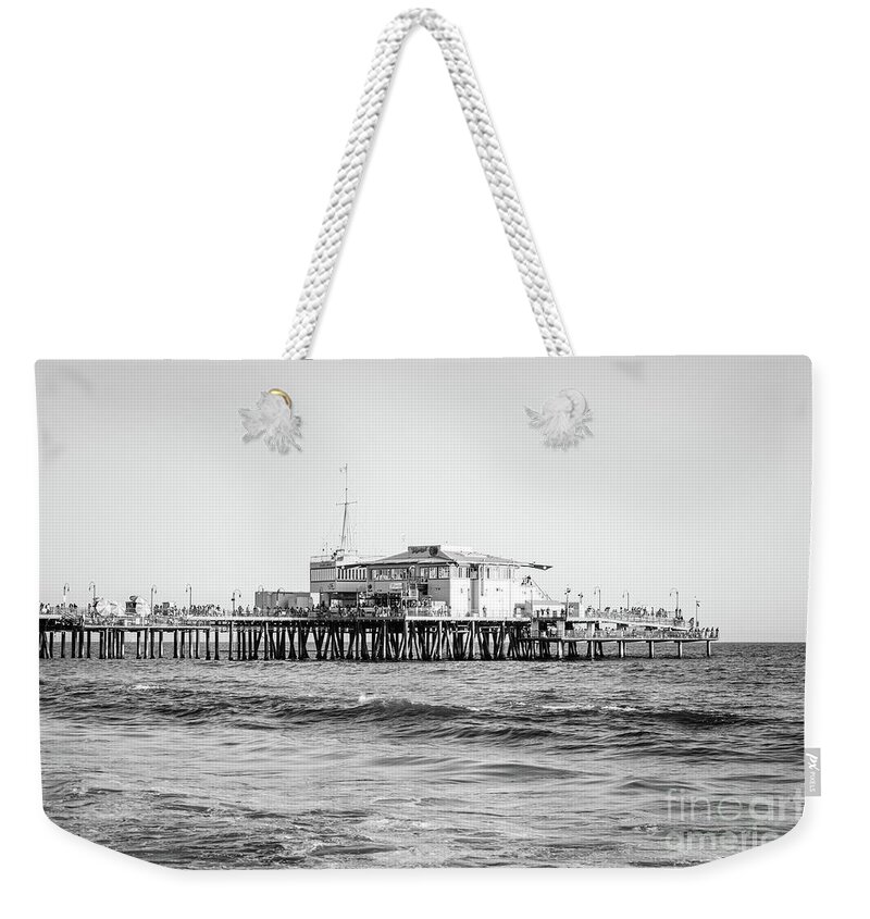 America Weekender Tote Bag featuring the photograph End of Santa Monica Pier Black and White Photo by Paul Velgos