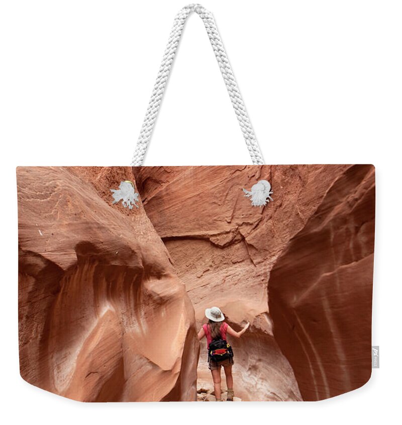Extreme Terrain Weekender Tote Bag featuring the photograph Exploring Woman Hiking Slot Canyon by Milehightraveler