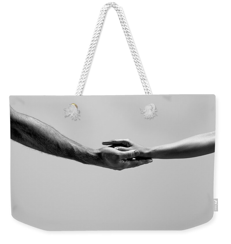Young Men Weekender Tote Bag featuring the photograph Female And Male Hands by Jonathan Knowles
