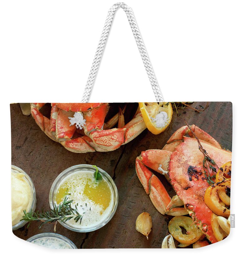 Roast Dinner Weekender Tote Bag featuring the photograph Fire Roasted Dungeness Crabs On Wooden by Lisa Romerein