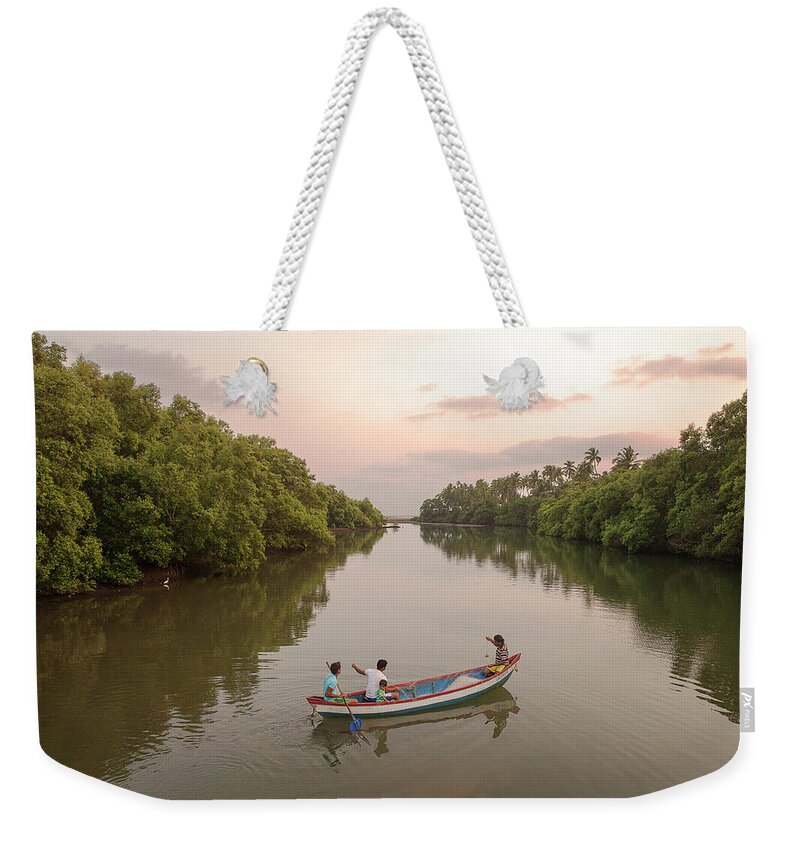 Tranquility Weekender Tote Bag featuring the photograph Fisherman In Creek In Goa,india by Zak Kendal