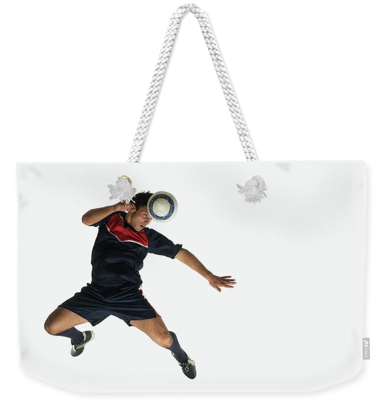 Footballer Heading Ball In Mid-air Weekender Tote Bag by John Lamb 