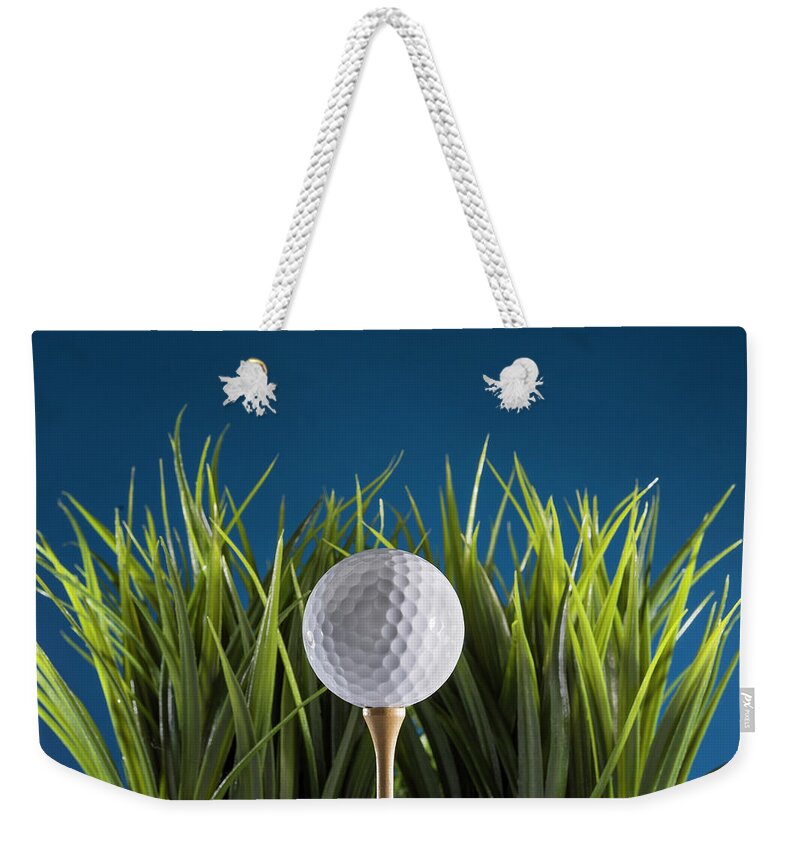 Golf Weekender Tote Bag featuring the photograph Golf ball on tee by Deborah Ritch