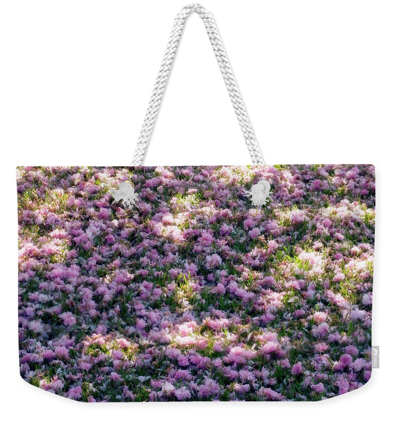 Grass Weekender Tote Bag featuring the photograph Grass Covered With Flower Petals by Maria Mosolova