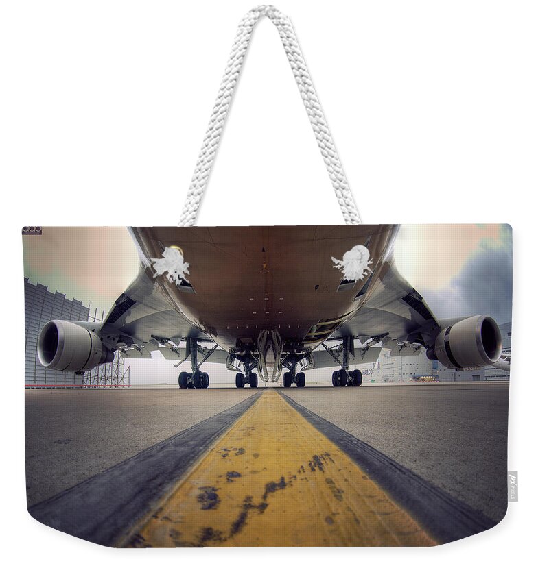 Outdoors Weekender Tote Bag featuring the photograph Ground Level Shot Of Plane by Happykiddo Photography