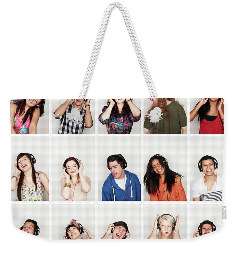 Young Men Weekender Tote Bag featuring the photograph Group Of People Listening To Headphones by Flashpop