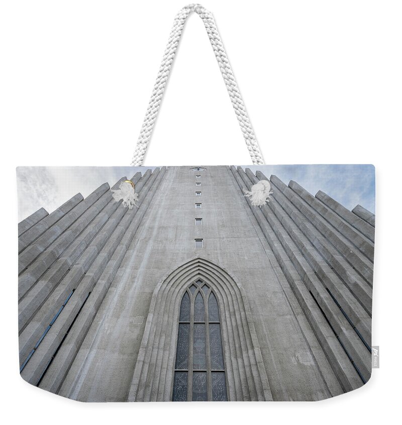 Iceland Weekender Tote Bag featuring the photograph Hallgrimskirkja facade and bell tower in Reykjavik by RicardMN Photography