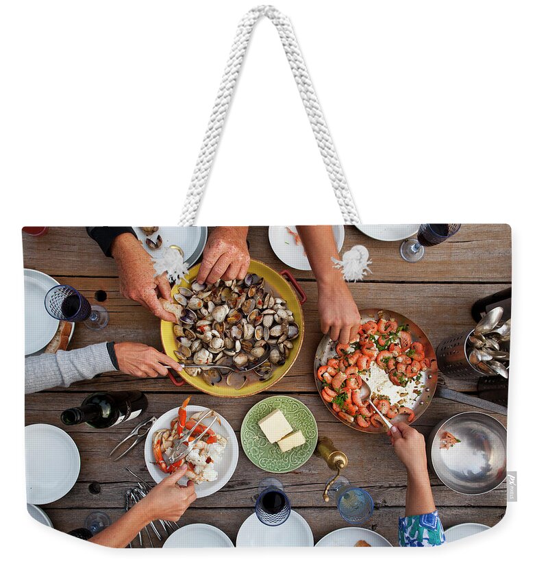 Human Arm Weekender Tote Bag featuring the photograph Hands Serving Shellfish Meal Around by Lisa Romerein
