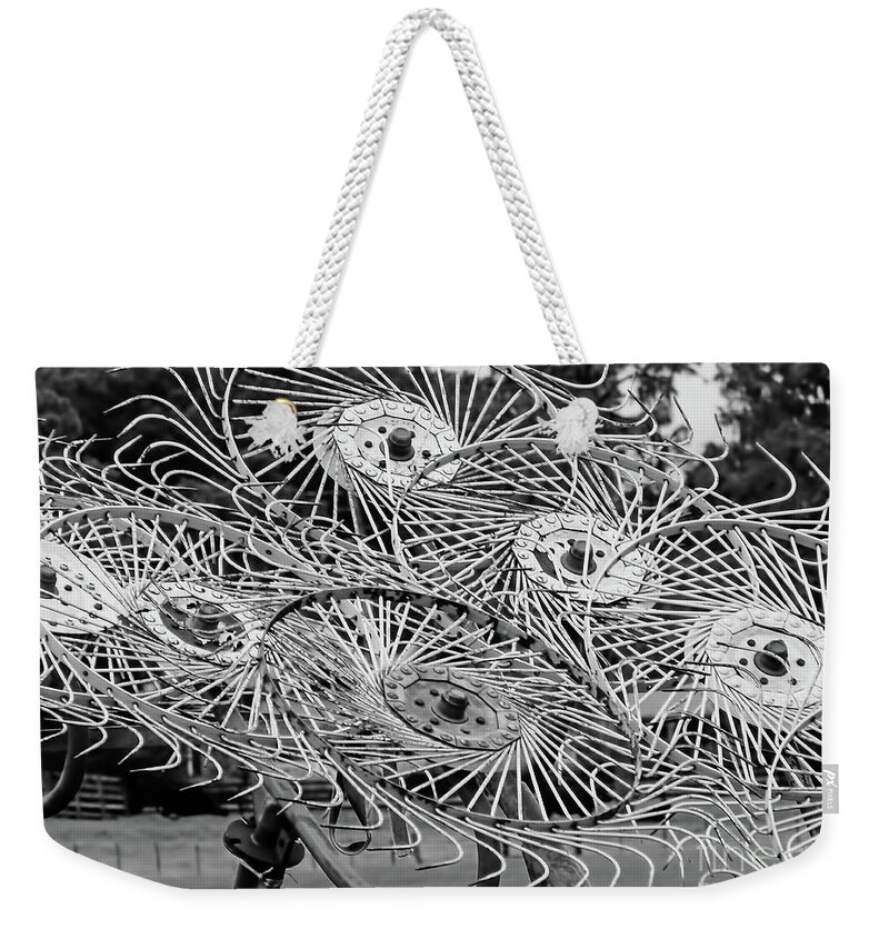 A Wheel Rake Weekender Tote Bag featuring the photograph Hay Rake Black and White by D Hackett