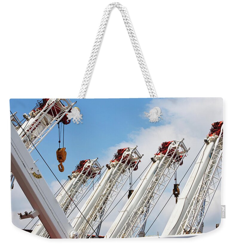 In A Row Weekender Tote Bag featuring the photograph Heavy Equipment by Fotog1
