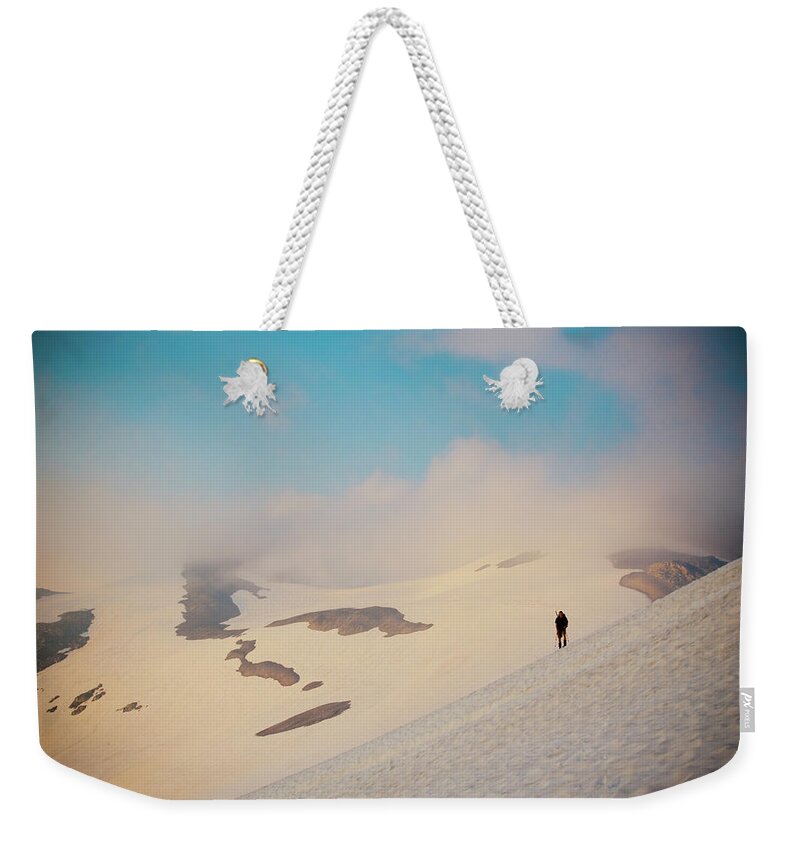 People Weekender Tote Bag featuring the photograph Hiker Crosses Snowfield by Christopher Kimmel