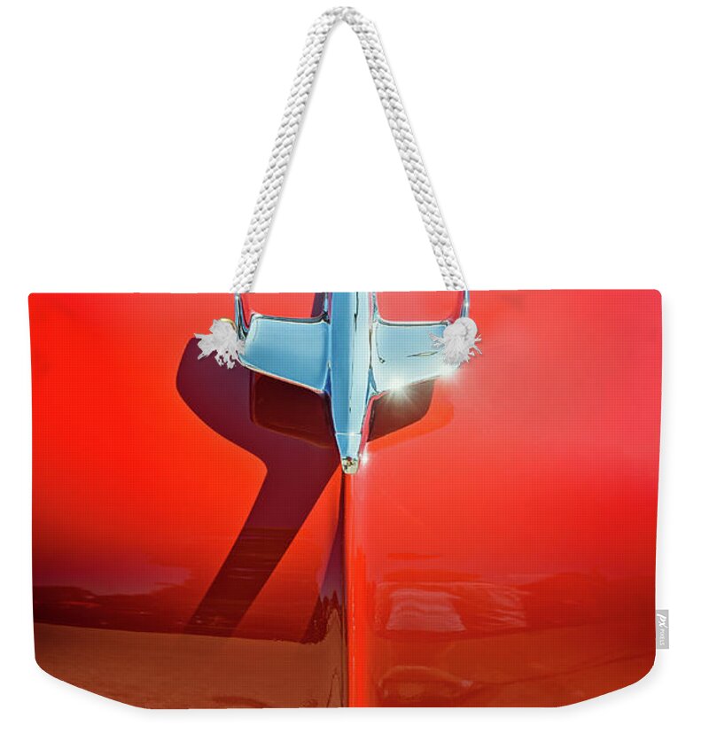 Vehicle Weekender Tote Bag featuring the photograph Hood Ornament on a Red 55 Chevy by Scott Norris