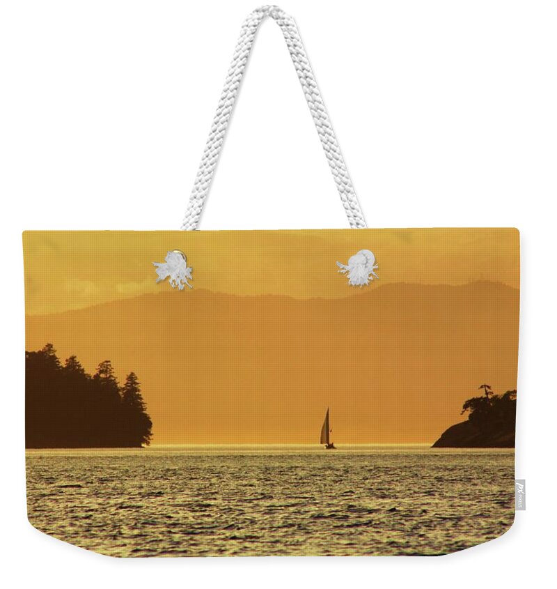 Golden Weekender Tote Bag featuring the photograph Into the Sunset by Fred Bailey