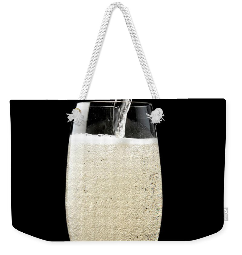Alcohol Weekender Tote Bag featuring the photograph Isolated Shot Of Pouring Champagne by Kyoshino