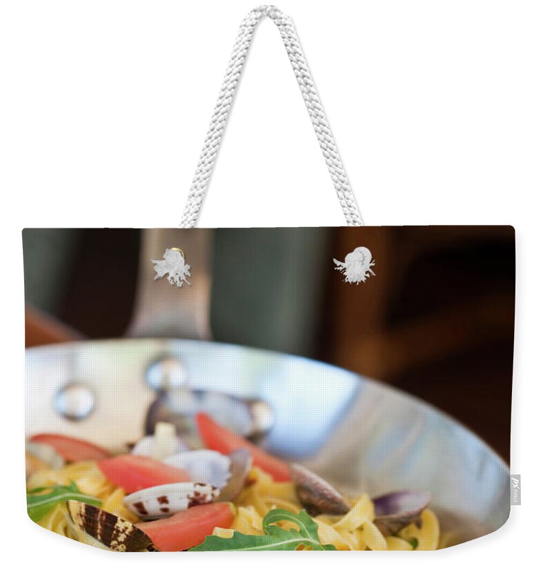 Estock Weekender Tote Bag featuring the digital art Italy, Tuscany, Siena District, Chianti, Castelnuovo Berardenga, Tagliolini With Clams And Cherry Tomatoes With Rucola On A Cream Of Zucchini At Restaurant Poggio Rosso At Borgo San Felice by Stefano Scata