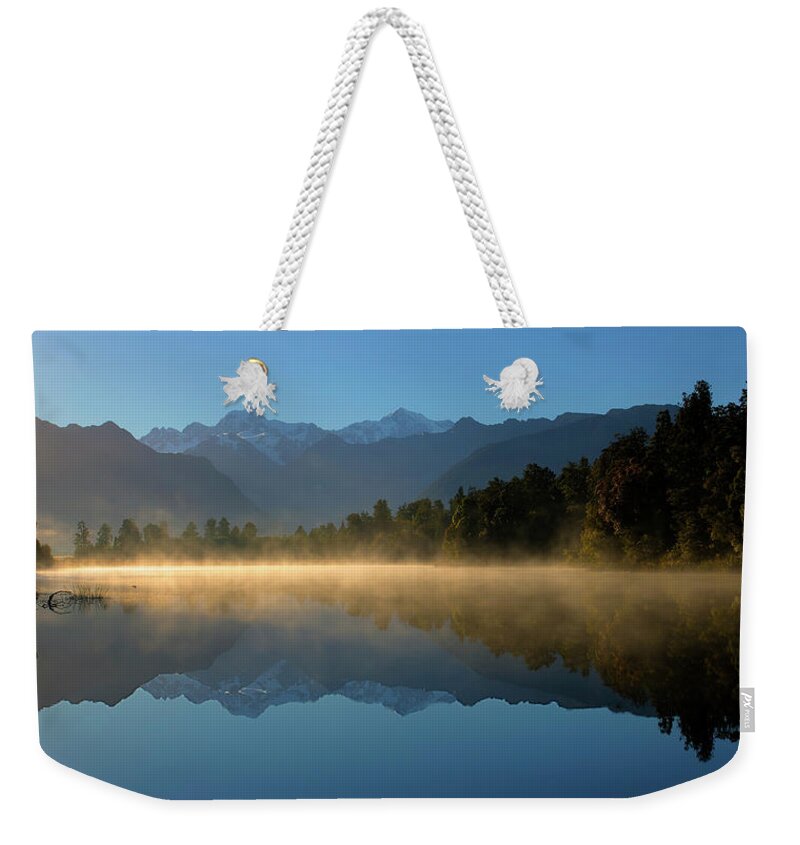 Lake Matheson Weekender Tote Bag featuring the photograph Lake Matheson Morning by Peter Kennett
