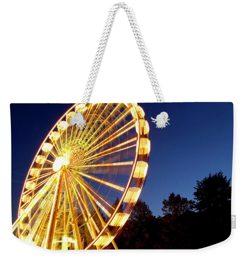 Curve Weekender Tote Bag featuring the photograph Lighted Ferris Wheel Spinning In Motion by Vfka