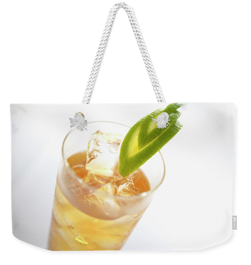 Ip_11970652 Weekender Tote Bag featuring the photograph Limonetta With Ice Cubes by Kaktusfactory