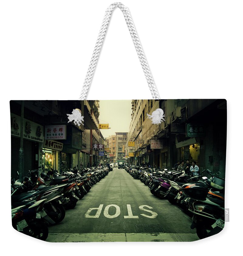 Macao Weekender Tote Bag featuring the photograph Line Of Motor Bikes With Stop Sign On by D3sign