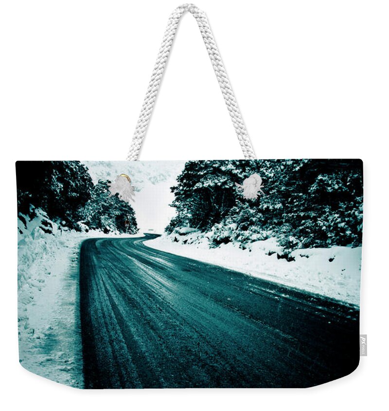 Adventure Weekender Tote Bag featuring the photograph Lonely road in the countryside for a car trip and disconnect from stress by Joaquin Corbalan