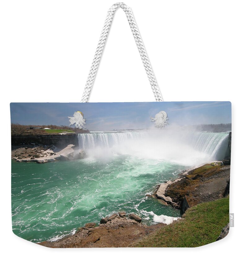 Water's Edge Weekender Tote Bag featuring the photograph Magnificient Niagara Falls by Buzbuzzer