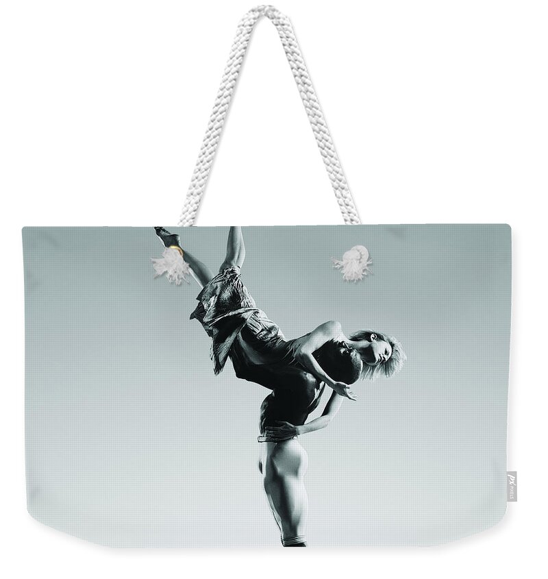 Expertise Weekender Tote Bag featuring the photograph Male Dancer Supporting Female Dancer In by Chris Nash