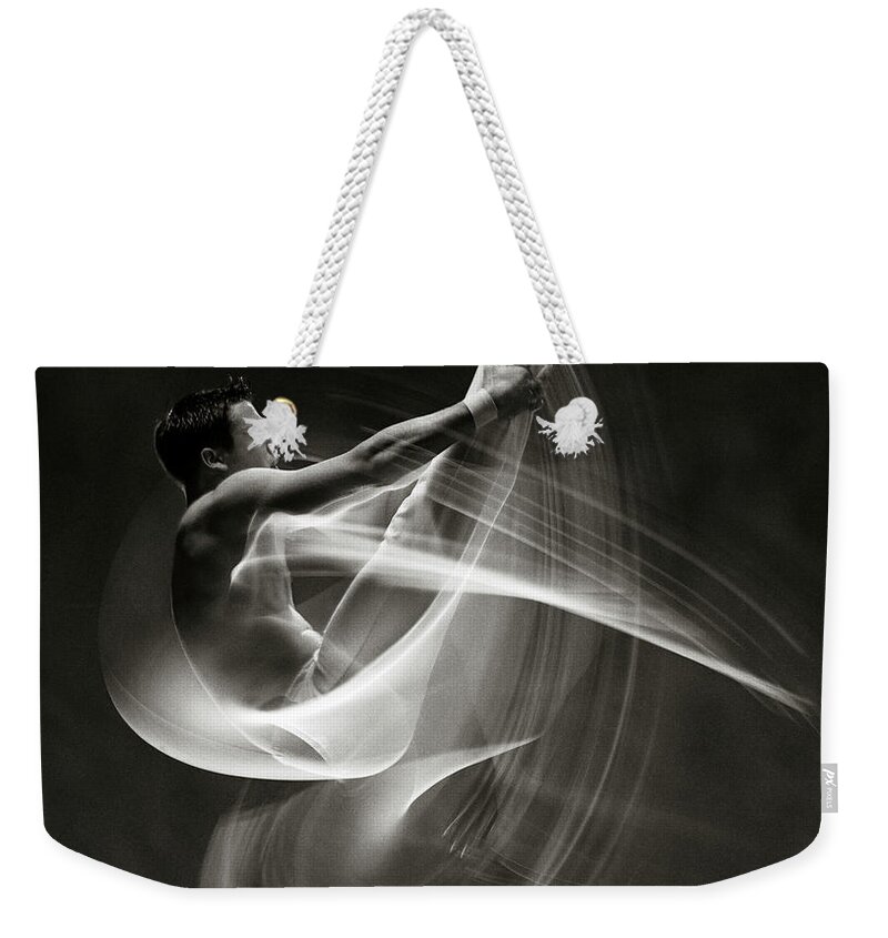 One Man Only Weekender Tote Bag featuring the photograph Male Gymnast Performing Somersault by Ray Massey